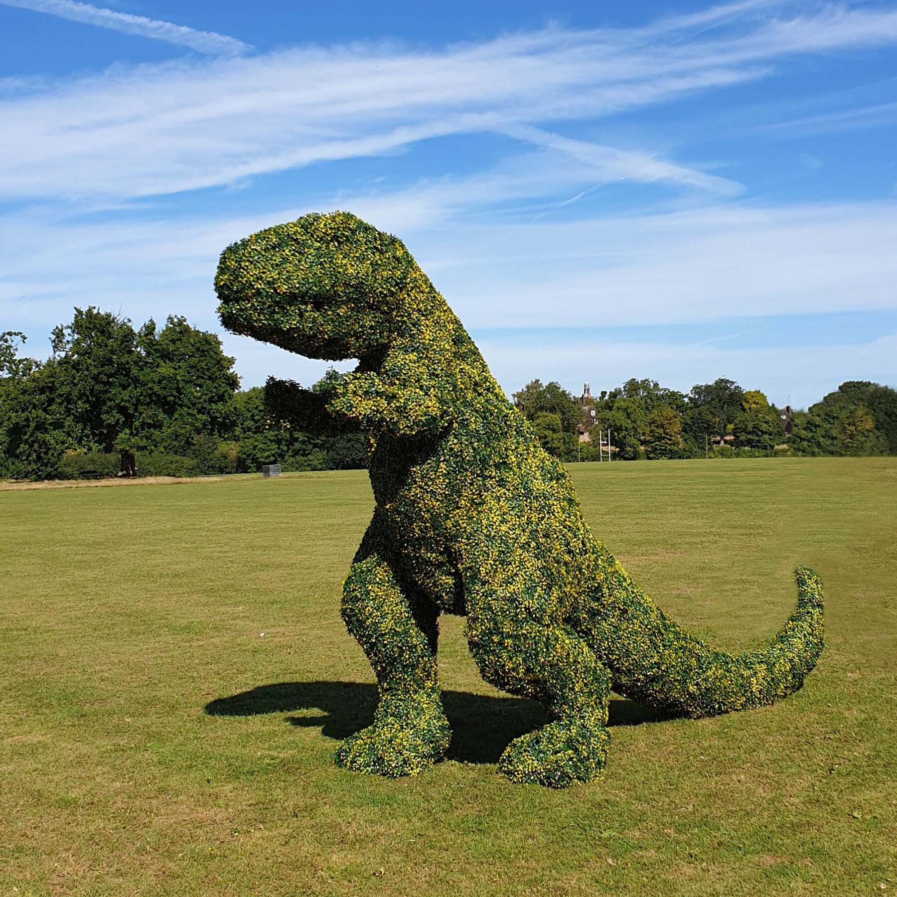 artificial boxwood topiary tiles used to cover a fake dinosaur