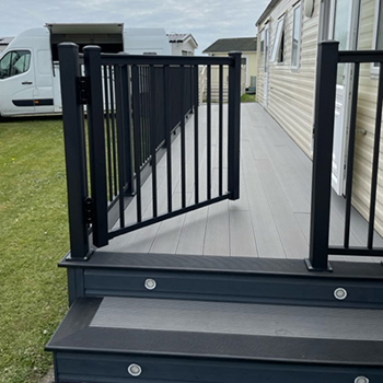 aluminium balustrade edging a decked area wrapping around a holiday home