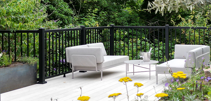 Aluminium black powder coated balustrade in a modern garden that has a floating decked area