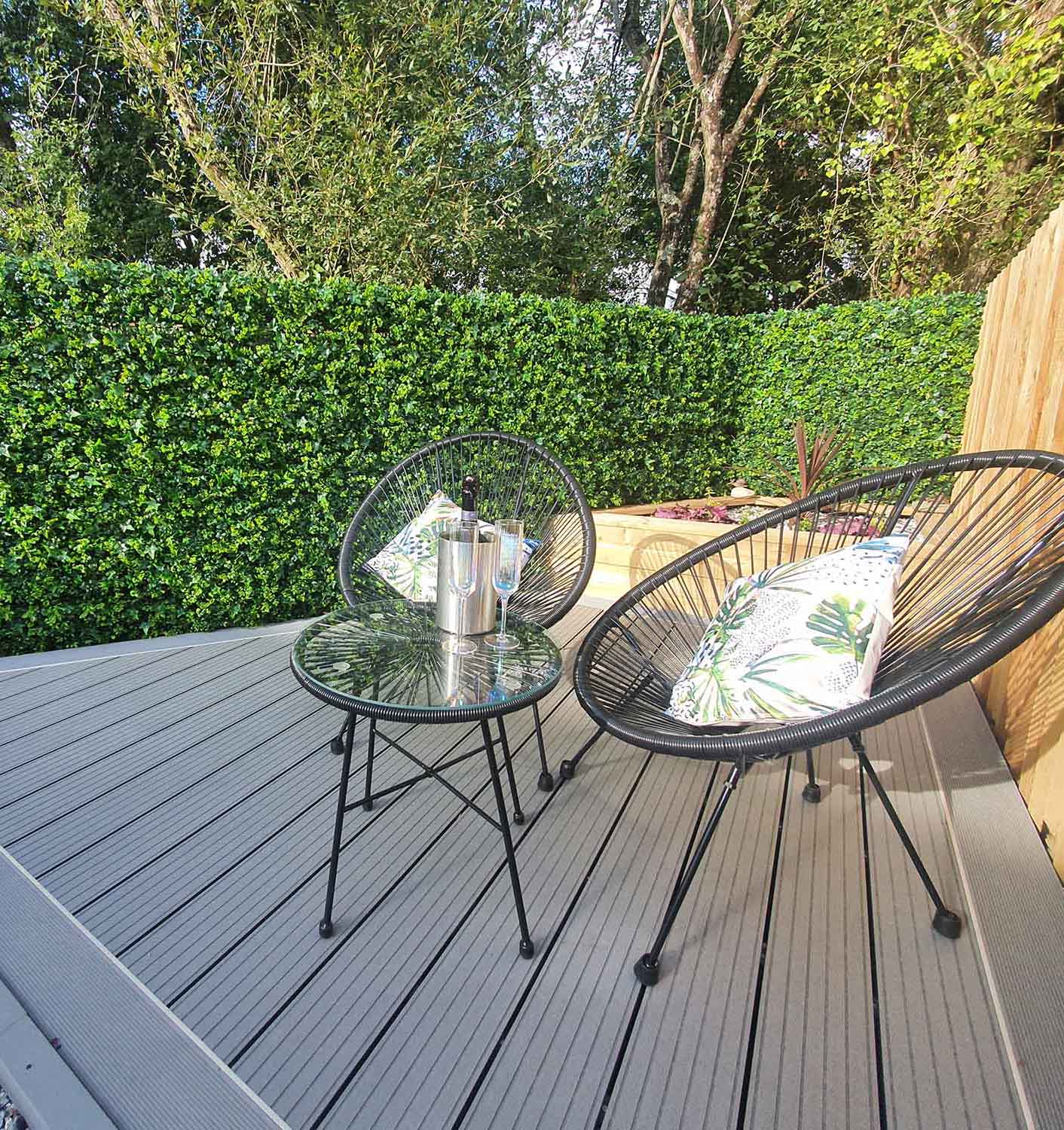 Amazon artificial hedge tiles used on a wooden fence