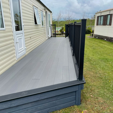 static home with wrap around decking and aluminium balustrade edging it