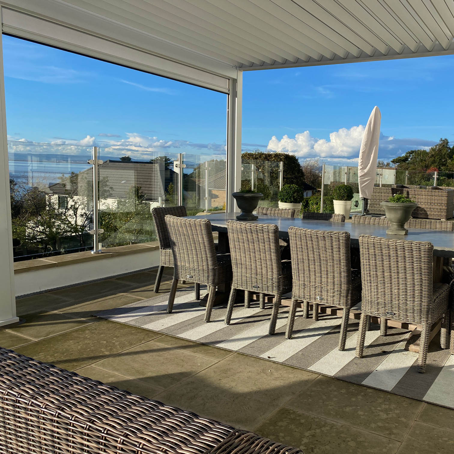 semi-frameless glass balustrade system installed on a raised patio