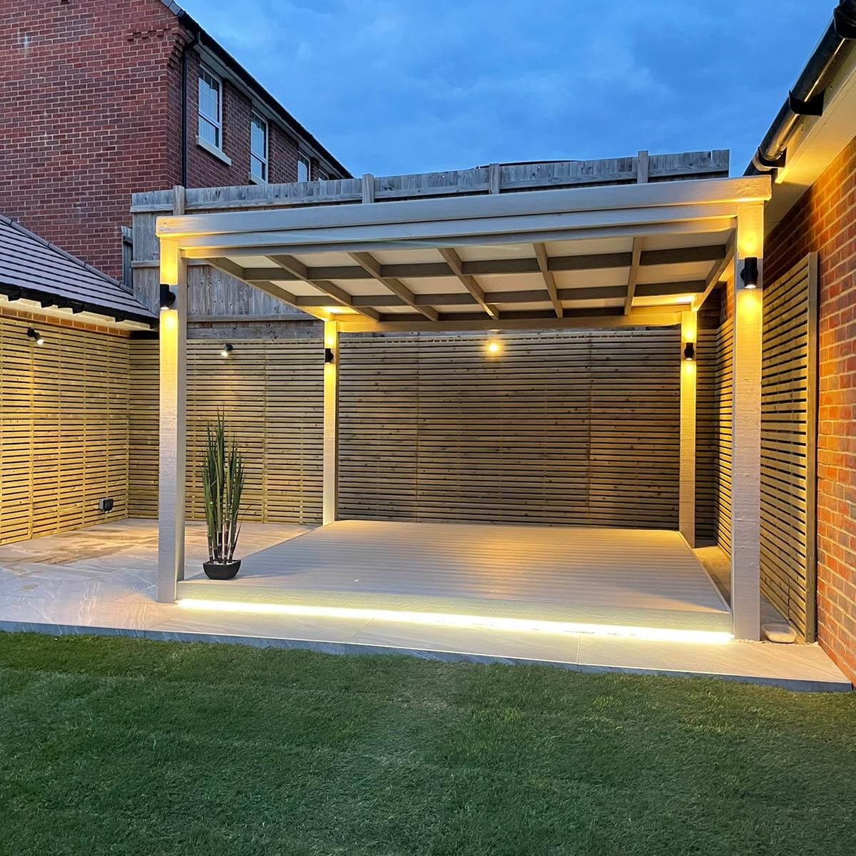 ash white composite decking lit up at night