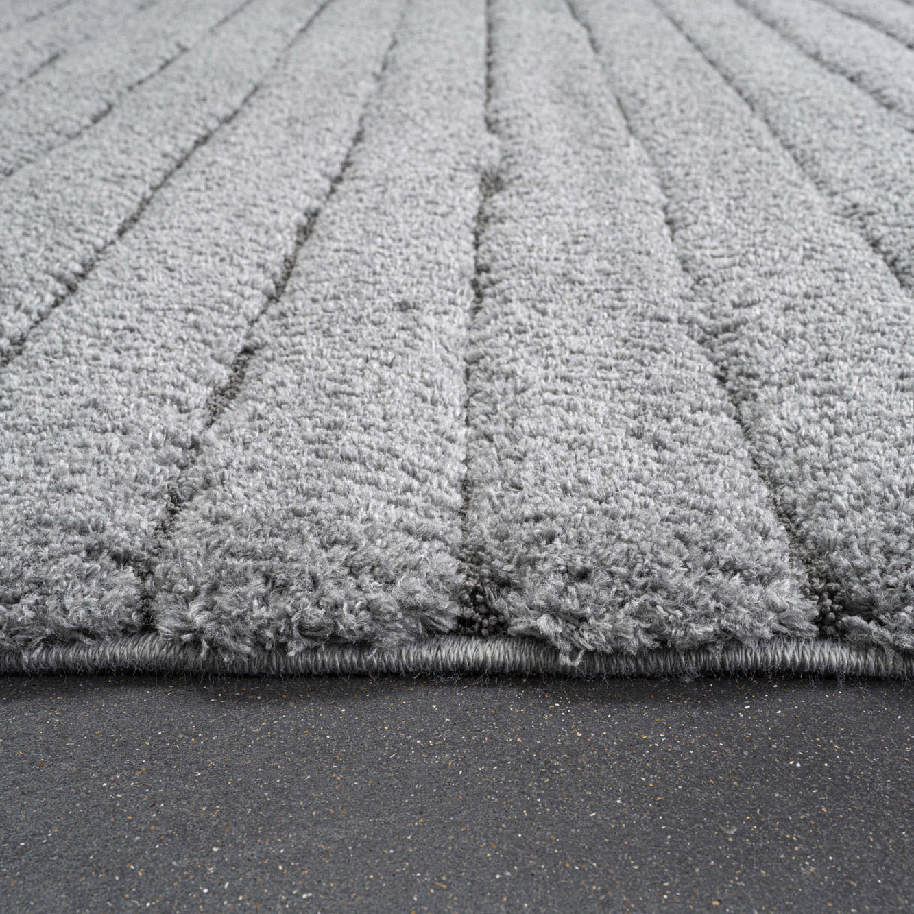 close up of Dune stripe luxury dark grey coloured rug