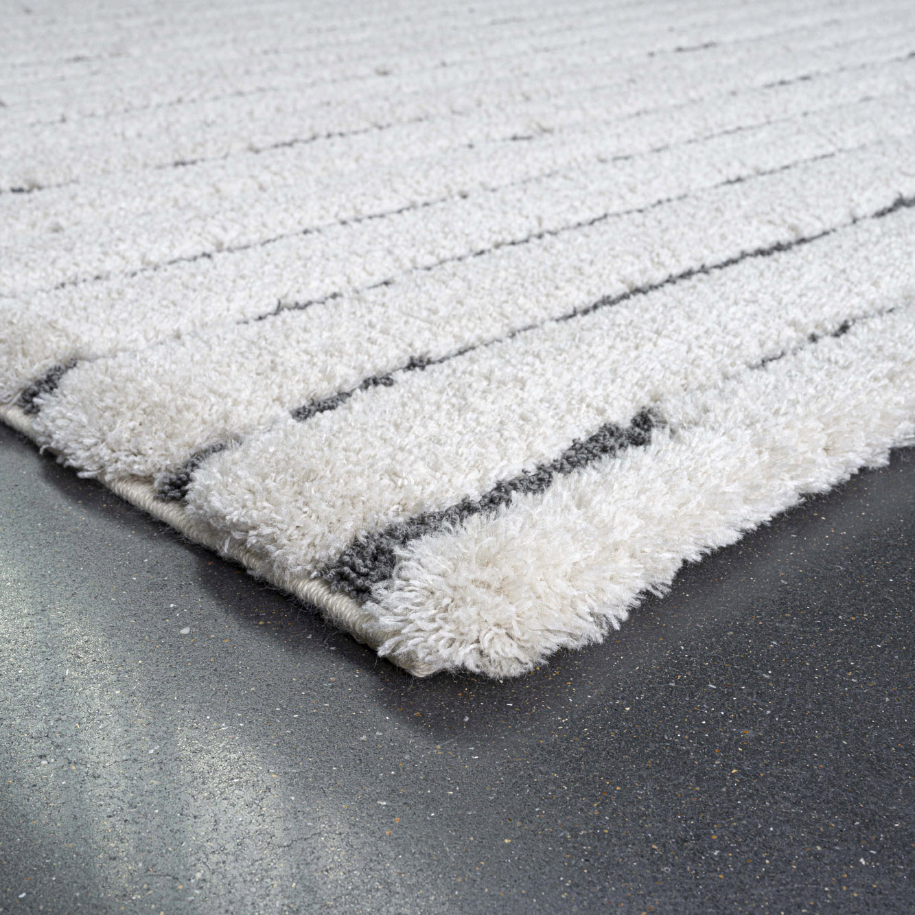 angled view of Dune stripe luxury cream coloured rug