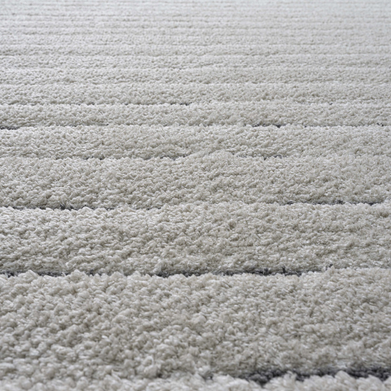 close up of 25mm pile of Dune stripe luxury cream coloured rug