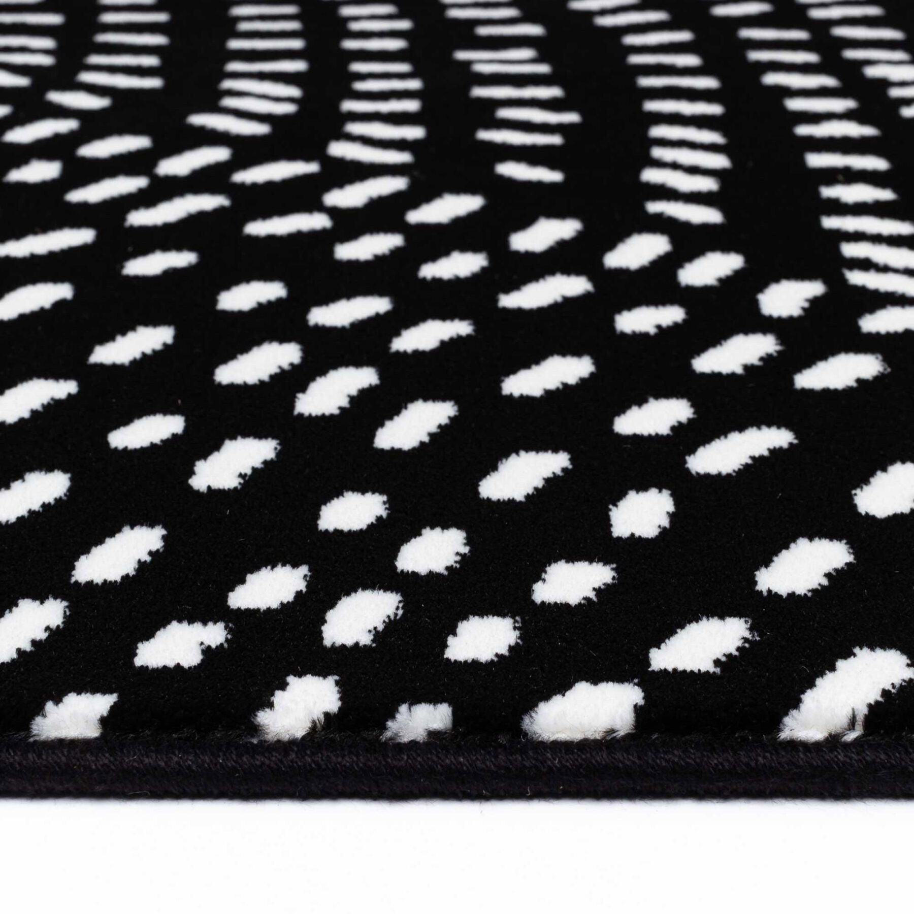 Tiago indoor rug spotted design black background with white spots